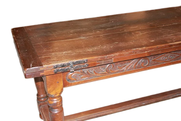 Large rustic table from the early 19th century, extendable embellished with carving motifs